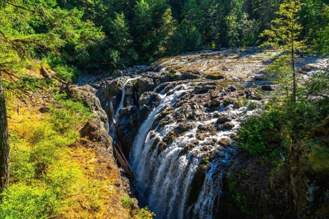Englishman river falls creates a stunning natural spectacle as water cascades down rocky cliffs