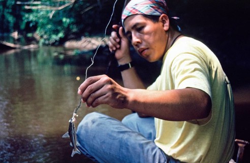 Man caught fish to be used as bait for piranhas, Rio Yanayacu, Amazon region near Iquitos, Peru,