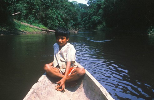 Little boy in a canoe, Rio Yanayacu, Amazon region near Iquitos, Peru, South America, September