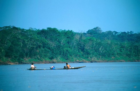 Boat traffic on the Rio Tambopata near Puerto Maldonado in the Amazon Basin, Peru, South America,