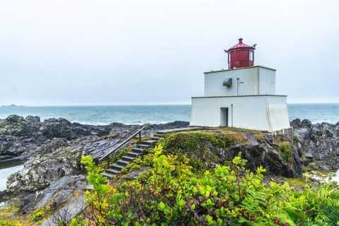 The amphitrite point lighthouse stands on the rocky coast of ucluelet, vancouver island, providing