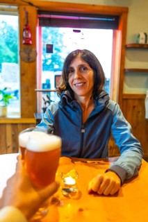Tourist enjoying a refreshing craft beer in a cozy pub in ucluelet, a charming town on vancouver