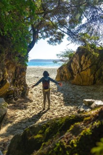 Female tourist with open arms enjoying breathtaking view of mackenzie beach after hiking through