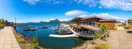 Modern architecture blends seamlessly with the natural beauty of tofino's harbor, featuring boats