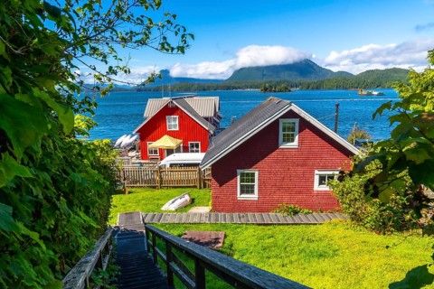 Wooden stairs leading down to red houses in tofino, british columbia, canada with clayoquot sound