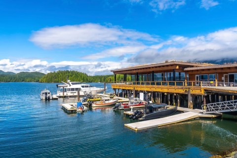 Modern architecture buildings overlooking clayoquot sound with boats moored at dock in tofino