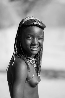 Black and white, portrait, brightly decorated girl winking, Hakaona tribe, also Havakona or