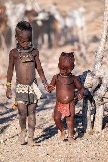 Himba children shake hands, traditional Himba village, Kaokoveld, Kunene, Namibia