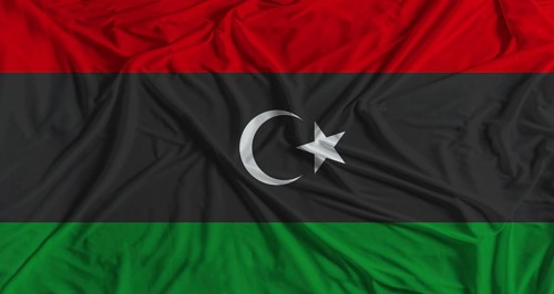 Libya flag with fabric texture background. National flag of Libya with cloth texture