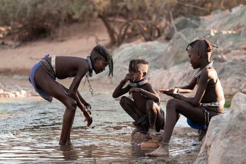 Himba children washing with water on a river, traditional Himba, Kaokoveld, Kunene, Namibia
