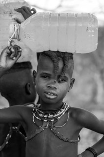 Black and white, Himba child fetches water, carries water bottle, traditional Himba, Kaokoveld,