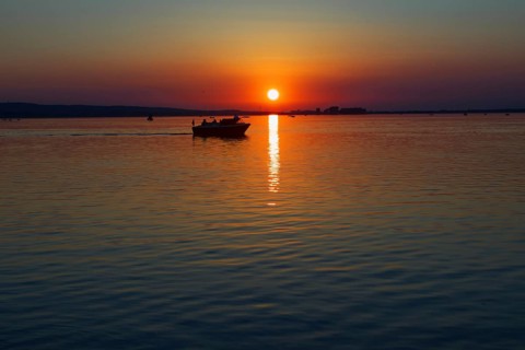 Sunset over the Steinhuder Meer with boat at dusk, quiet scene, Steinhude