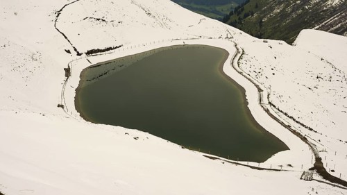 Another onset of winter in May, Riezler Alpsee, an artificially created lake, snow pond, feeds the
