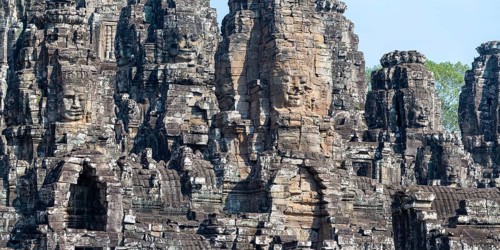 Panoramic picture of huge stone-carved faces of Bodhisattva Lokeshvara, also Avalokiteshvara, Bayon