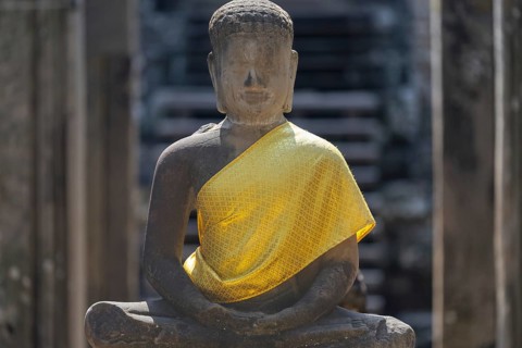 Sandstone Buddha statue, (Dhyana-mudra: gesture of meditation), with yellow tunic, on the north