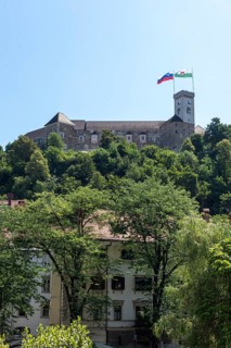 Ljubljana Castle towers over the city on a wooded hill, Ljubljana, Slovenia