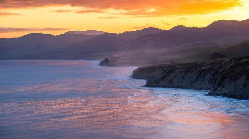 Wairarapa coast at sunset. Sea, mountains, backlight. Castlepoint, Wairarapa Coast, Wellington