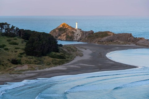 Deliverance Cove and Castlepoint Lighthouse on the rock, ocean, evening. Castlepoint, Wairarapa