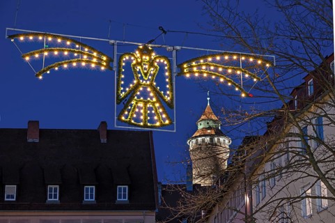 Historic Sinwell Tower illuminated in the evening, Christmas angel glowing in front for Advent, Old