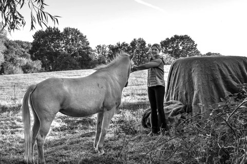 Young girl with her white horse in the pasture, black and white, Othenstorf, Mecklenburg-Western