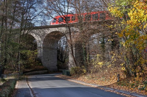 Regional train crosses the historic railway bridge, viaduct in Lauf, built in 1876,