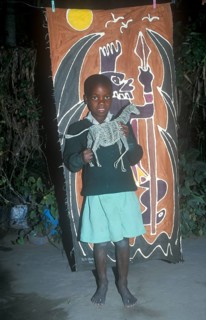 Child with homemade artwork in a self-help project in Chitungwiza near Harare, Zimbabwe, Africa,