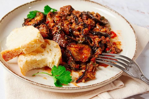 Stewed meat with eggplant is a Georgian dish, on a light background, homemade, no people