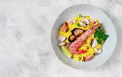 Seafood paella, on a plate, traditional Spanish dish, top view, no people