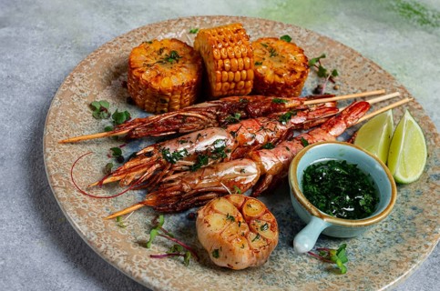 Langoustines on skewers, shrimp kebab, with fried corn, spices and herbs, homemade, no people