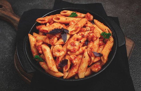 Penne pasta, with shrimp in tomato sauce, close-up, no people