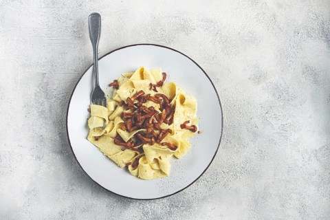 Pasta papardelle, in creamy garlic sauce, with mushrooms, traditional Italian cuisine, pasta