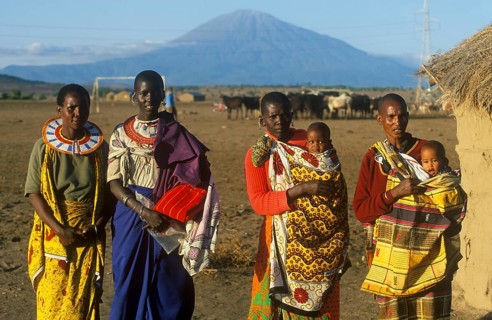 Women with babies pose for the camera in front of Mount Meru near Arusha, Tanzania, Africa, June