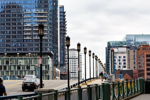 Street lights on Congress Street Bridge, passers-by on pedestrian walkway, office towers, Financial