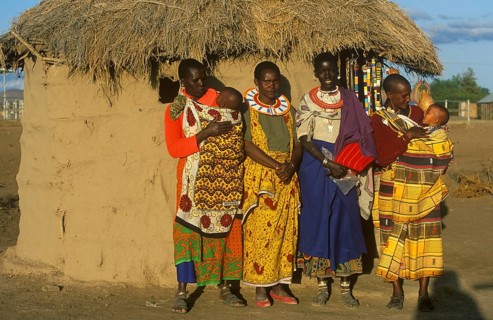 Maasai woman with babies in front of a clay hut near Arusha, Tanzania, Africa, June 2000, vintage,