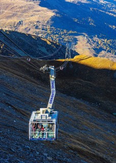 Visitors enjoy the view from the viewing terrace of a gondola from Grimentz to the Espace Weisshorn