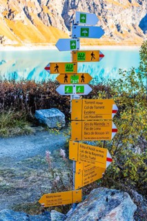 Information boards on trails for hikers and mountaineers, in the back the Lac de Moiry reservoir,