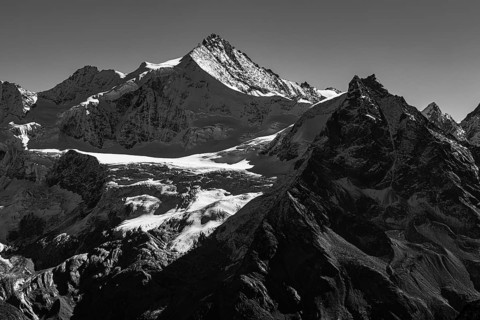 The snow-capped peaks of the Zinalrothorn and Besso mountains, black and white photo, Val
