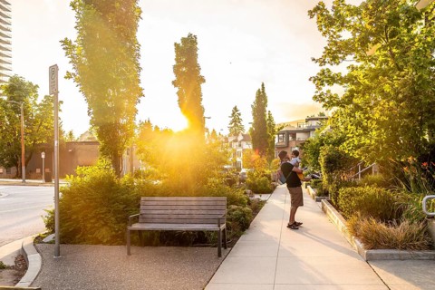 Father enjoying quality time with his baby while strolling through a vibrant vancouver park,