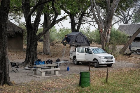 Campground, off-road car with roof tent, Xakanaxa, Moremi Game Reserve, Botswana