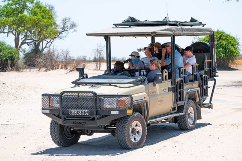 Safari car on safari with tourists in National Park, Savuti, Chobe National Park National Park,