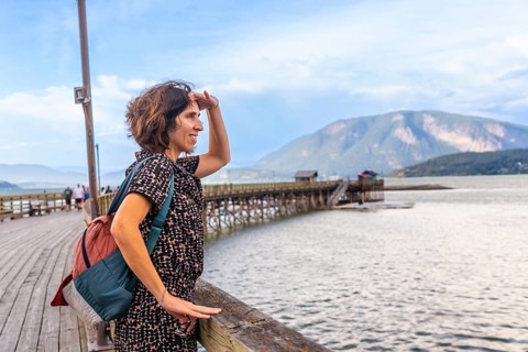 Female tourist shielding her eyes from the sun while enjoying the scenic view of the salmon arm