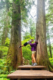Mother and son sharing a joyful moment on the giant cedars boardwalk trail, surrounded by majestic