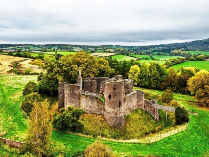 Autumn Colours over ruins of Grosmont Castle from a drone, Grosmont, Monmouthshire, Wales, UK