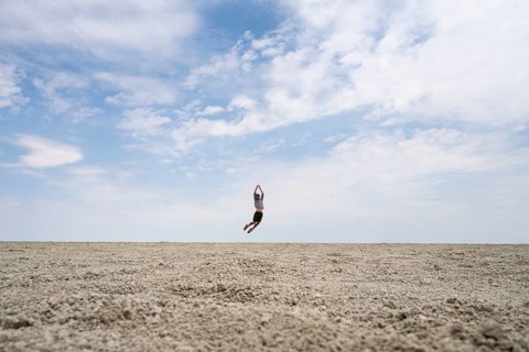 Symbolic picture, abstract, man jumping on the Etosha pan, salt pan, Etosha National Park, Namibia
