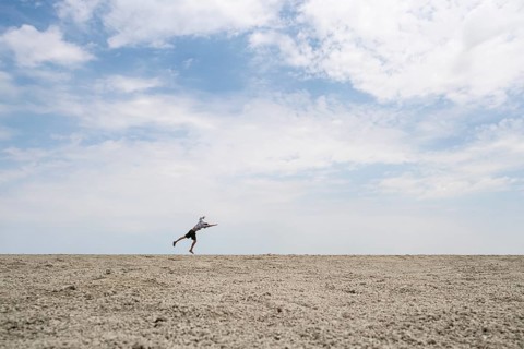Abstract, man jumping on the Etosha pan, salt pan, Etosha National Park, Namibia