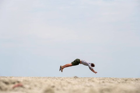 Abstract, man jumping horizontally at the Etosha pan, salt pan, Etosha National Park, Namibia