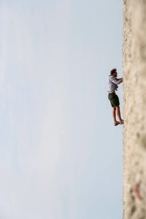 Symbolic picture, abstract, man climbing on wall, rotated image, on the Etosha pan, salt pan,