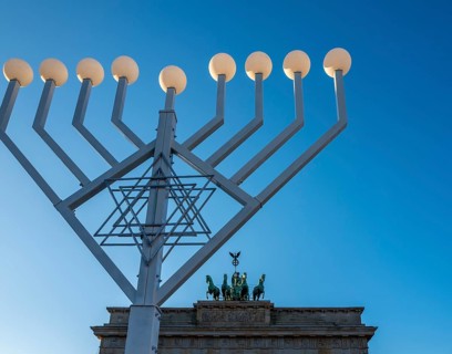 Large Hanukkah chandelier at the Brandenburg Gate in daylight, sign of lively Jewish life, symbolic