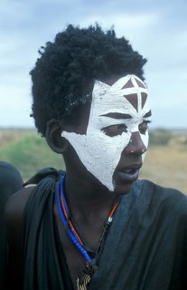 Portrait of a Maasai boy with face painted white on the occasion of his initiation, Ngorongoro