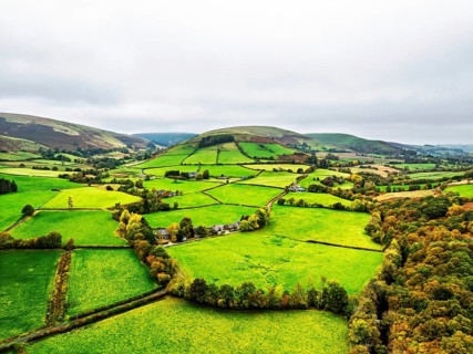 Autumn colours of Farms over River Wye and Road A470 from a drone, Llanidloes, Powys,